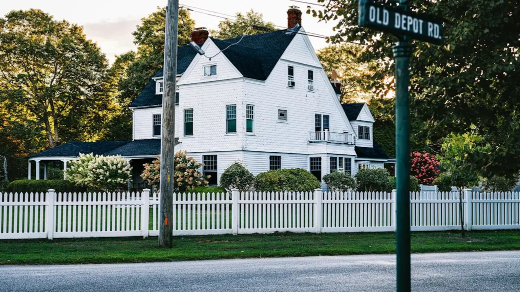 Quiet suburban street with single-family homes and mature trees