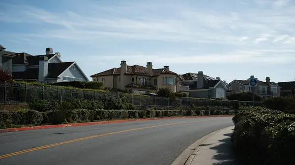 Houses along a gently sloping suburban street