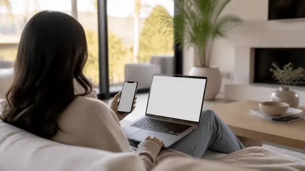 Home buyer browsing listings on a laptop in a bright living room