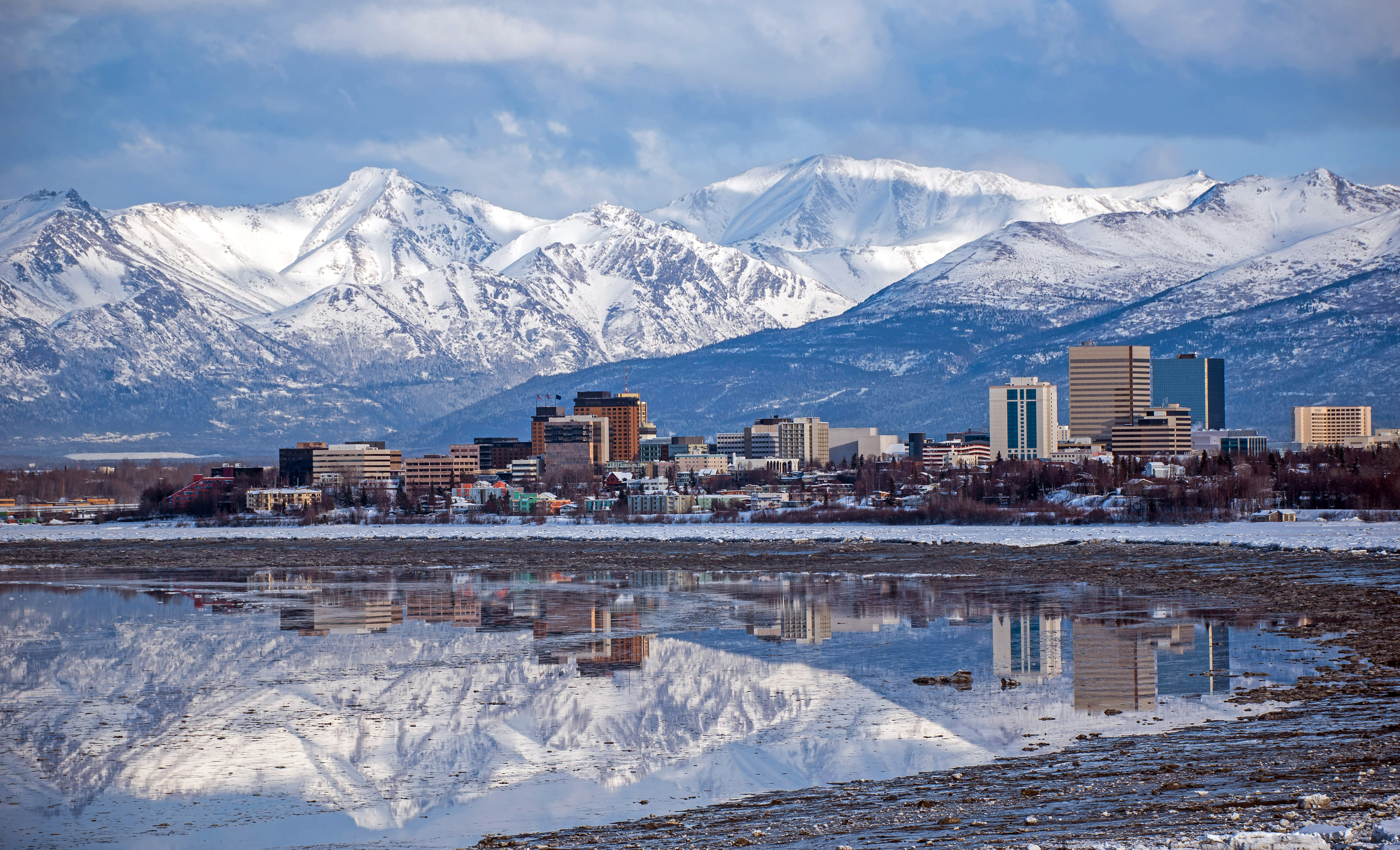 Anchorage, Alaska skyline backed by the snow-covered Chugach Mountains