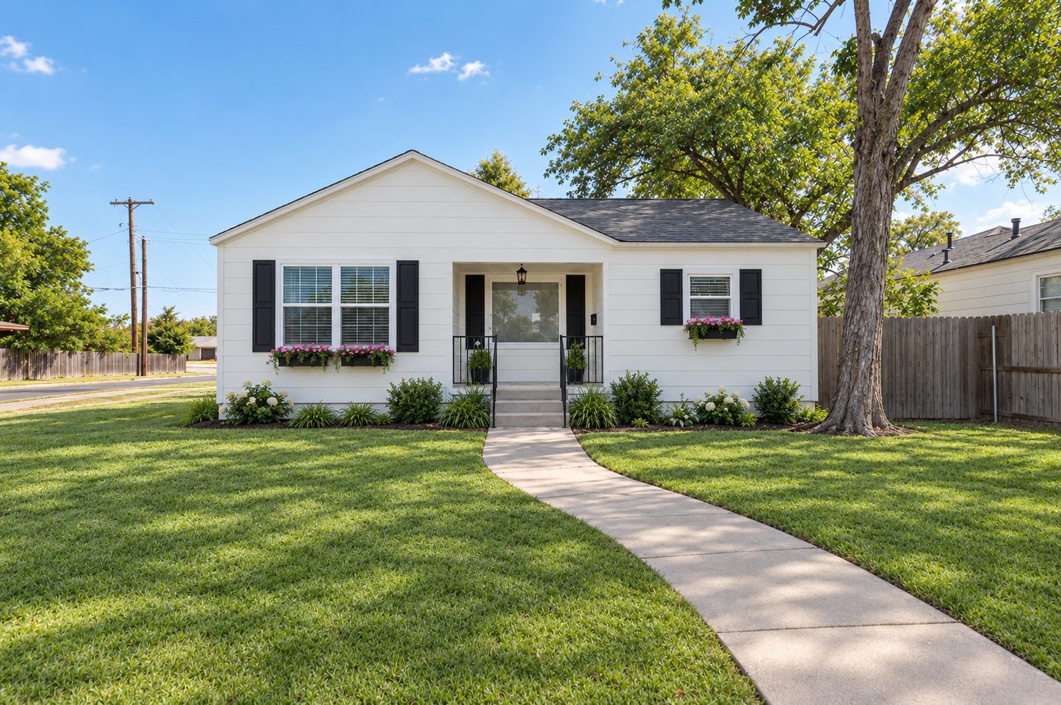 White single-story home with black shutters and a curved front walkway