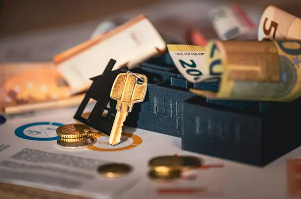House keys and coins on a table, symbolizing property tax savings