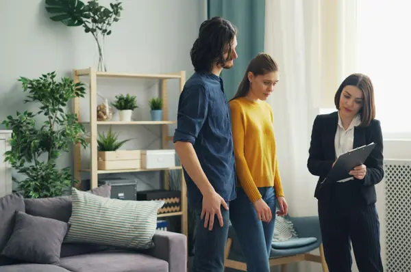Home inspector reviewing a report with homebuyers