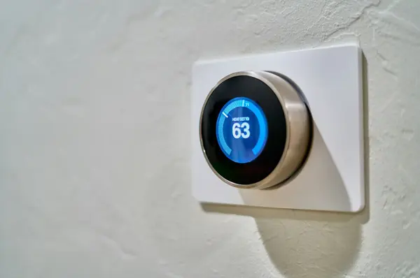 Smart thermostat on a living room wall