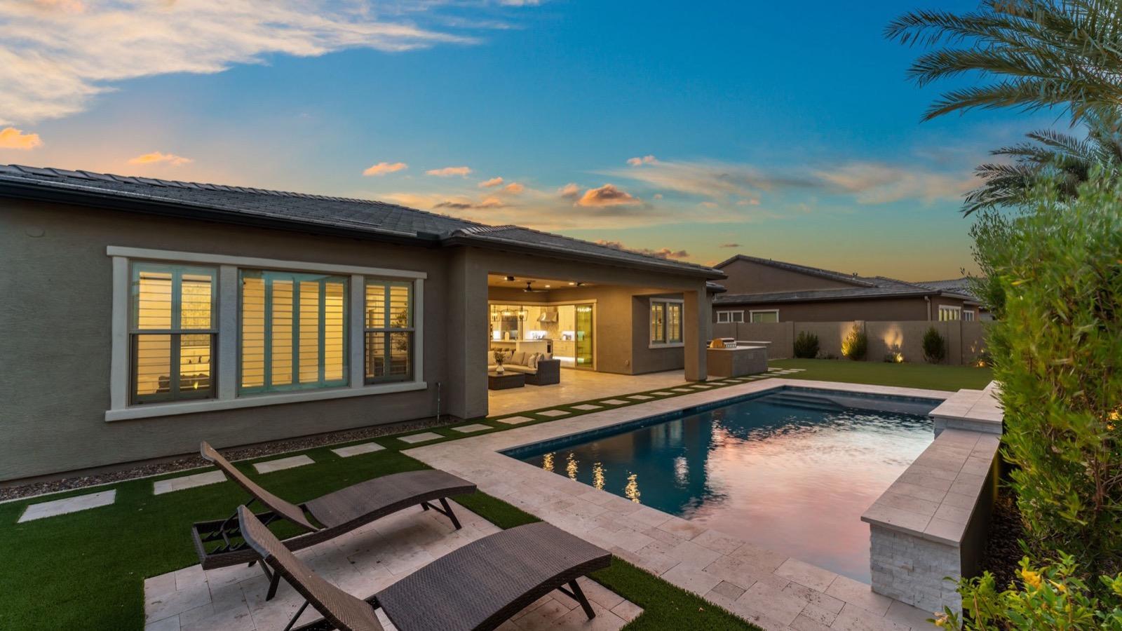 Home at dusk with pool and patio in Mesa, Arizona
