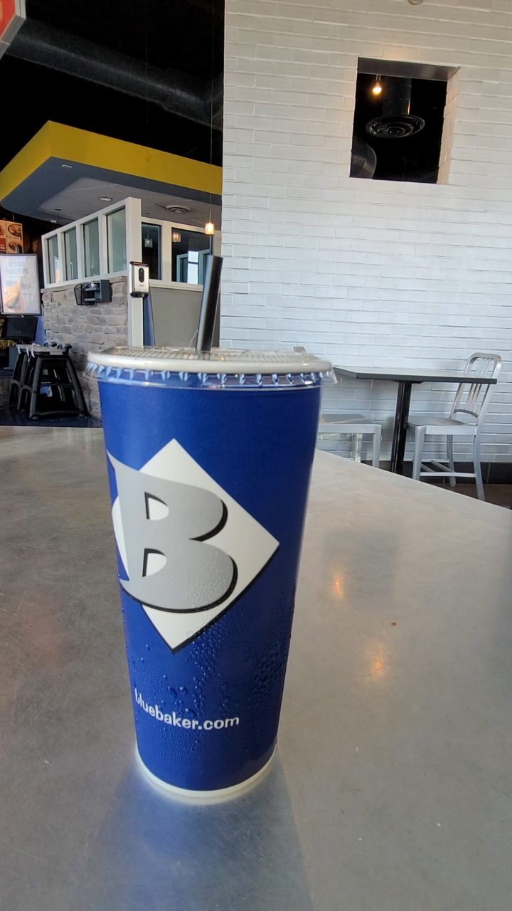 A Blue Baker cup on a table inside Blue Baker in College Station