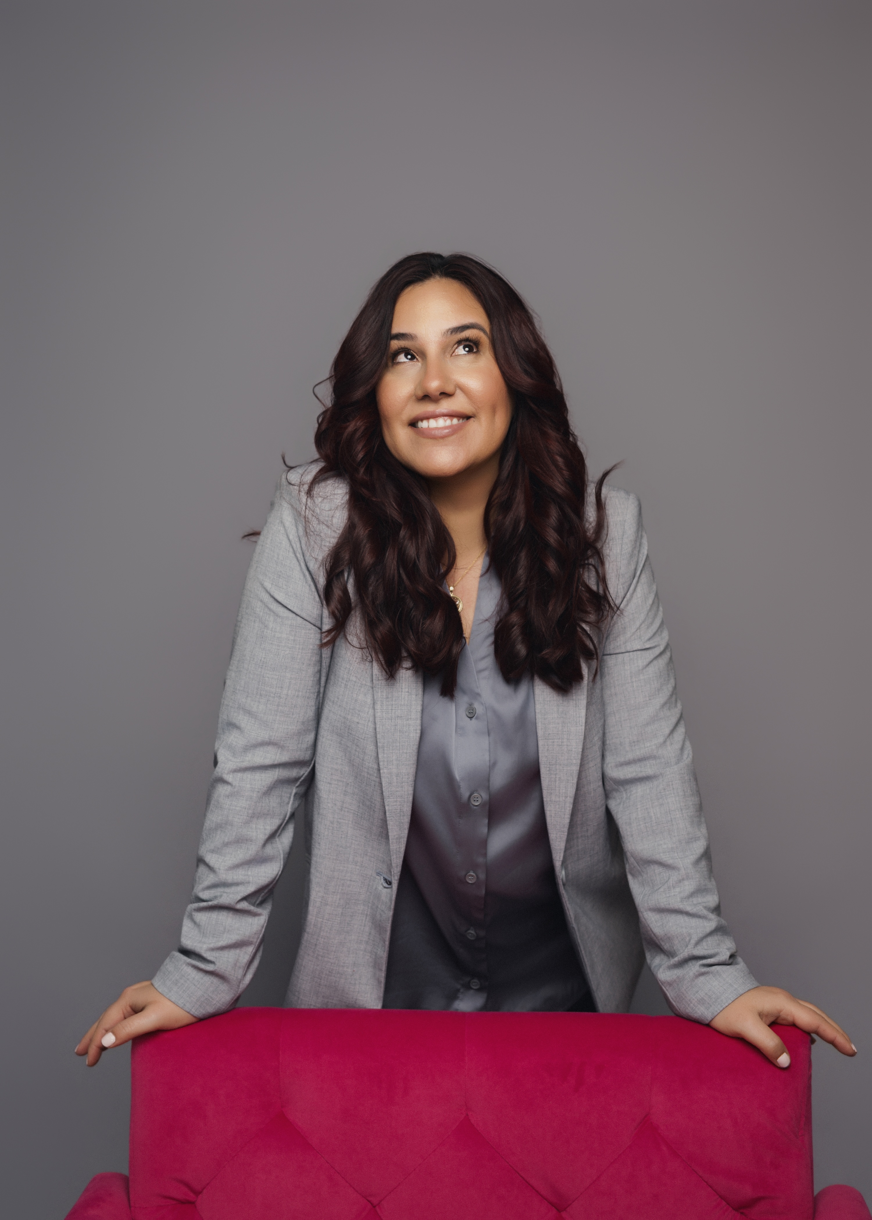 Monica Proenza, a real estate agent, wearing a grey suit