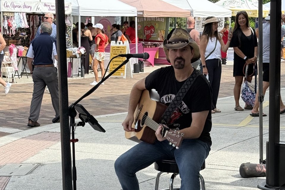 Musician playing guitar at the Winter Garden Farmers Market in downtown Winter Garden, Florida