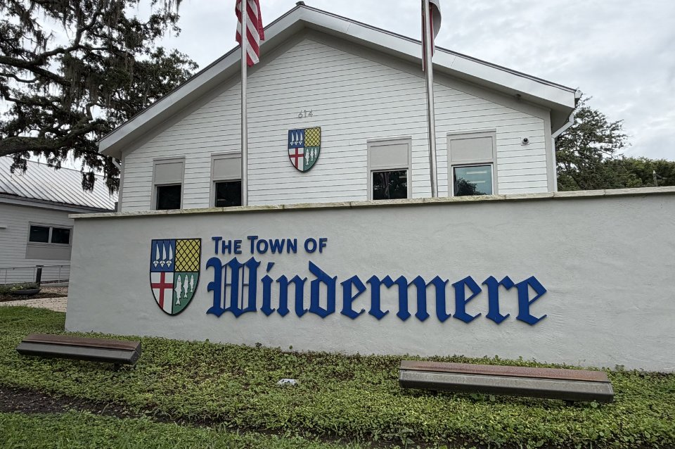 The Town of Windermere sign with flags in downtown Windermere, Florida