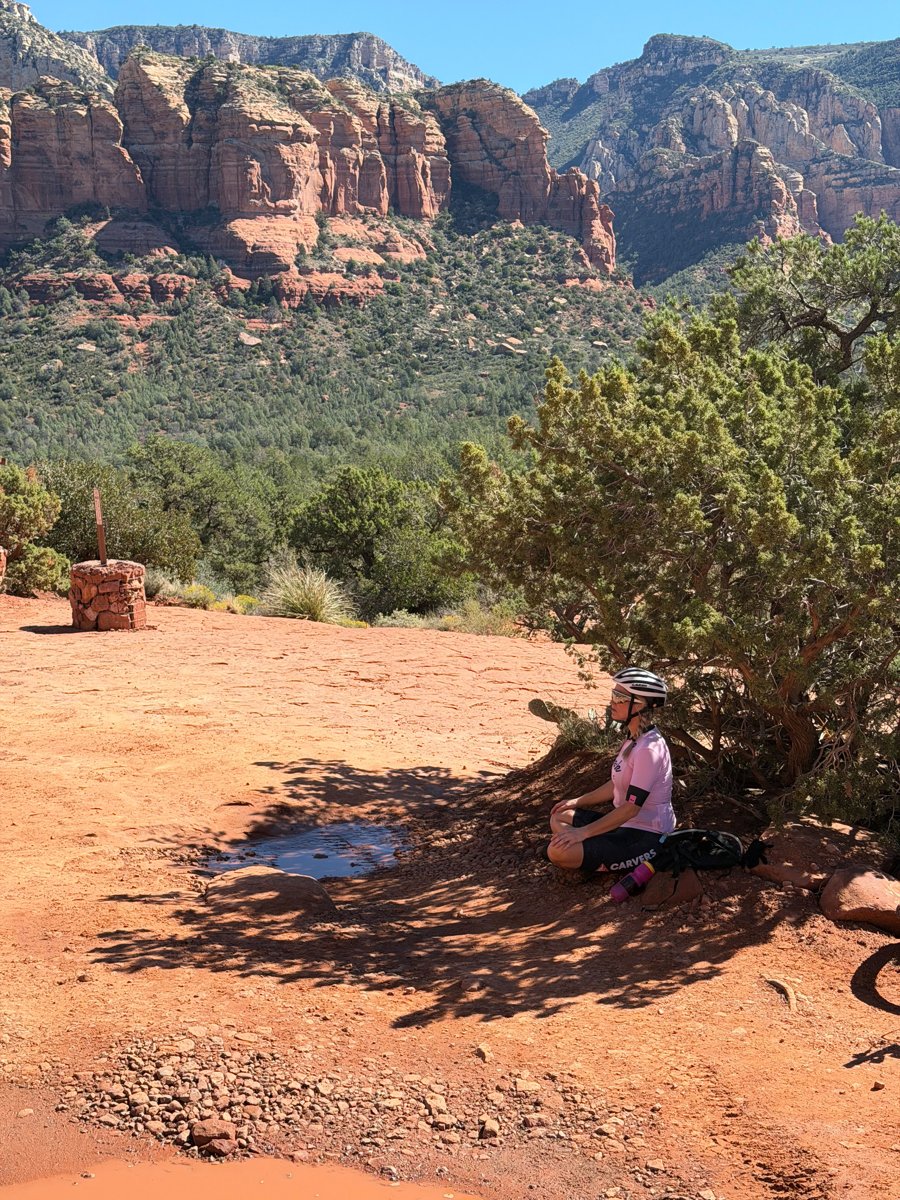 Heather meditating outdoors among the red rocks of Sedona