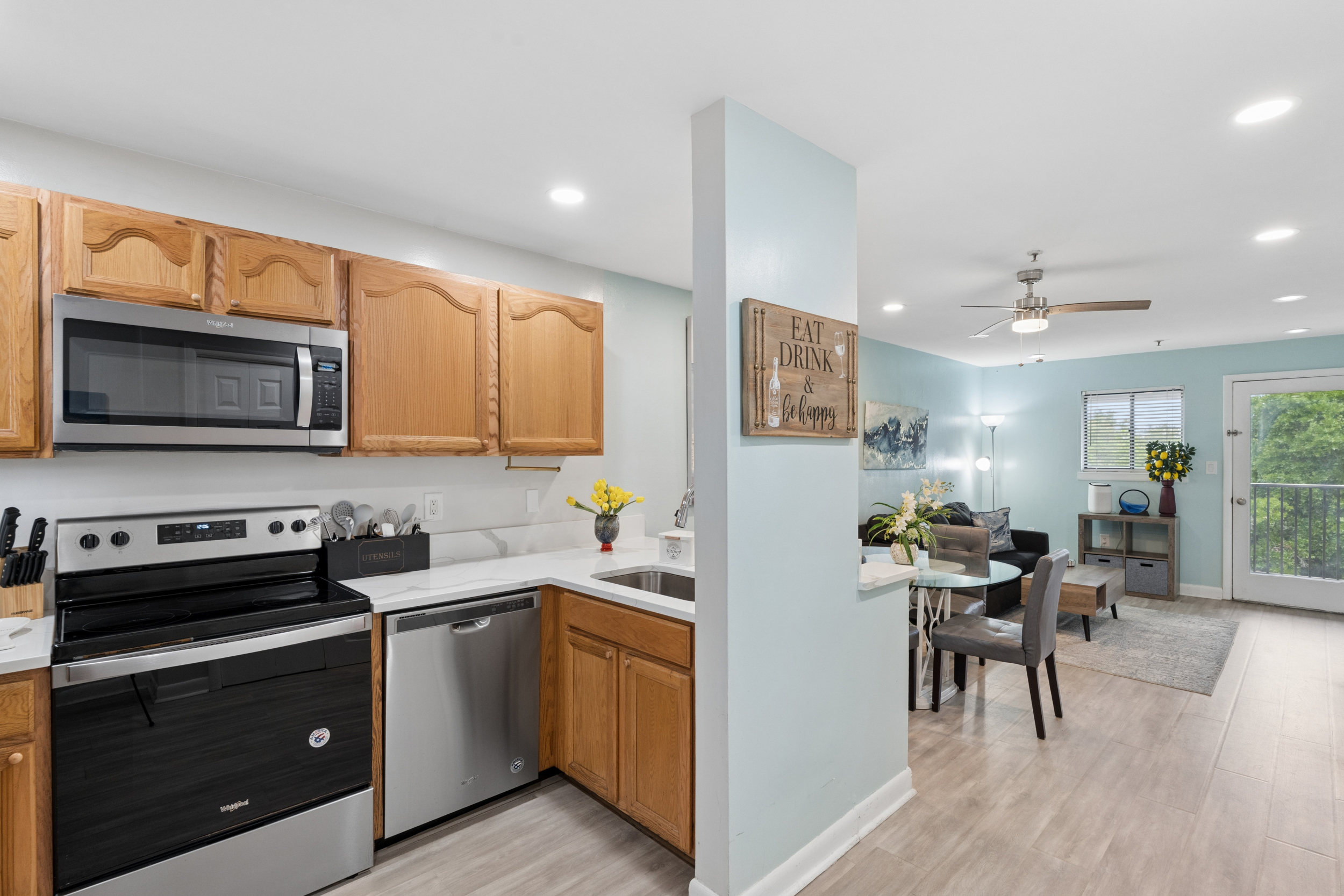 Open-concept kitchen, dining, and living area with private balcony access, Unit 4431, Hilton Head Resort